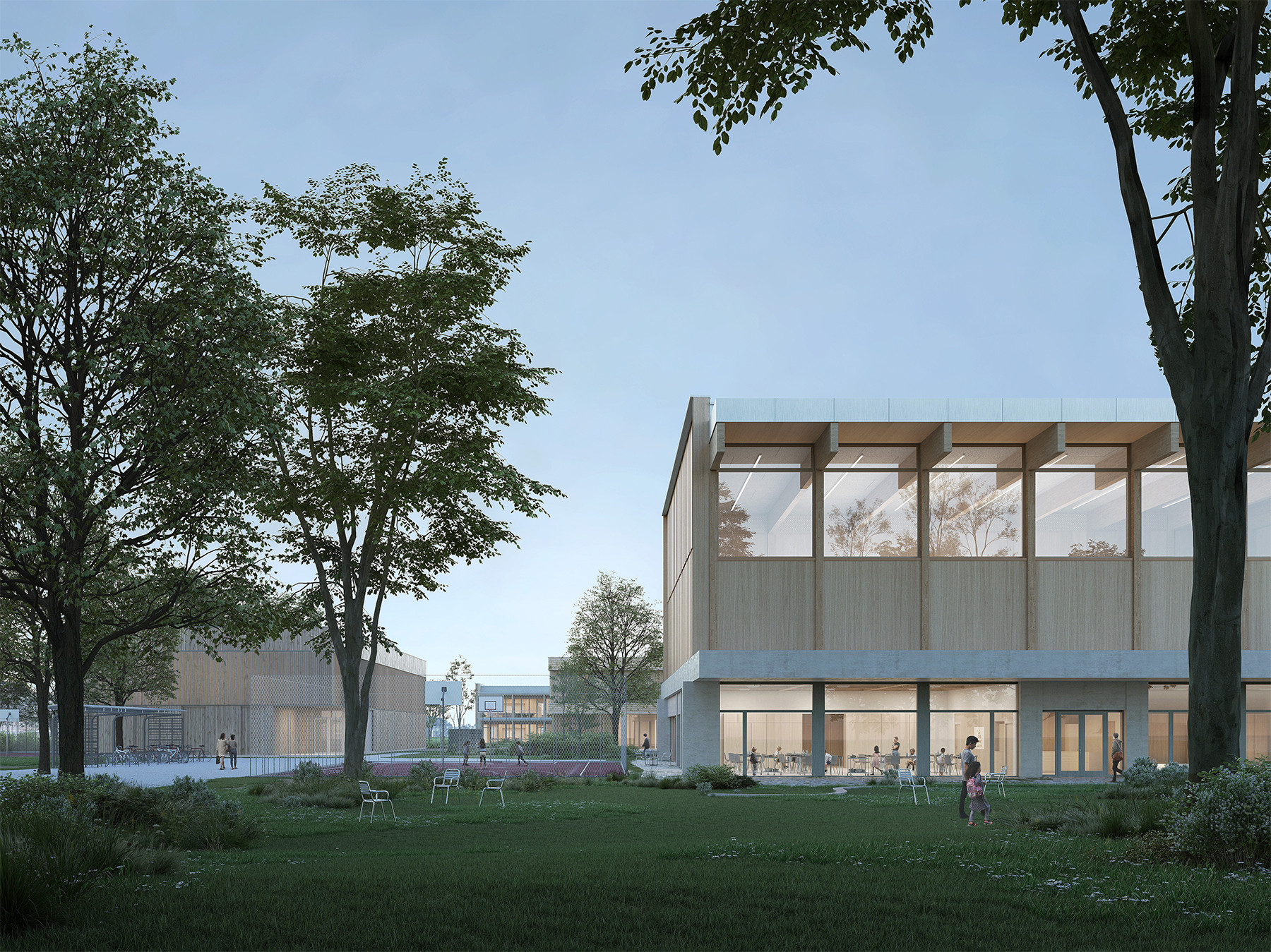 Abendliche Aussenansicht des Merzweckgebäudes St. Martin in Sursee mit beleuchtetem Innenraum und umgebendem Grünraum