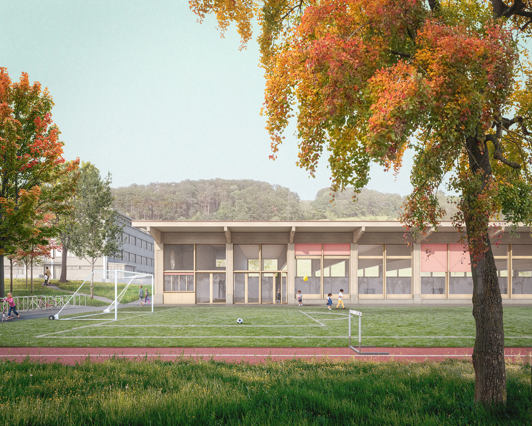 Ansicht der Dreifachsporthalle der Schulanlage Hofacker in Triengen mit Sportfeld und begrünter Umgebung